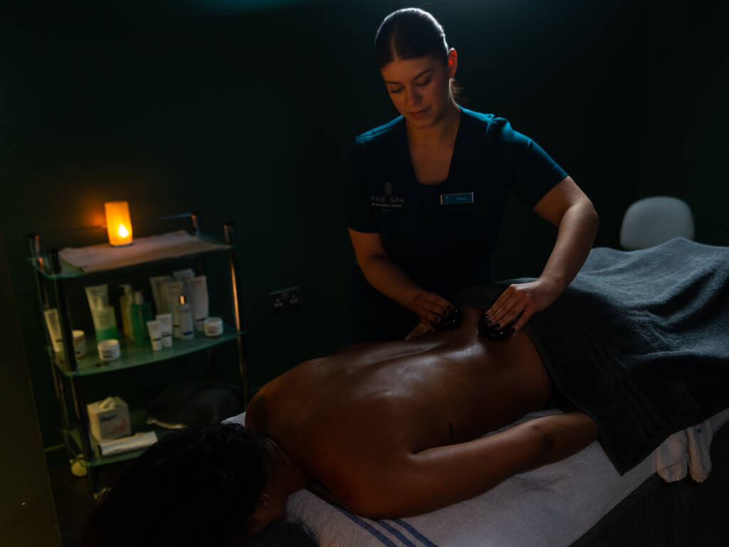 A person getting a back massage at the spa