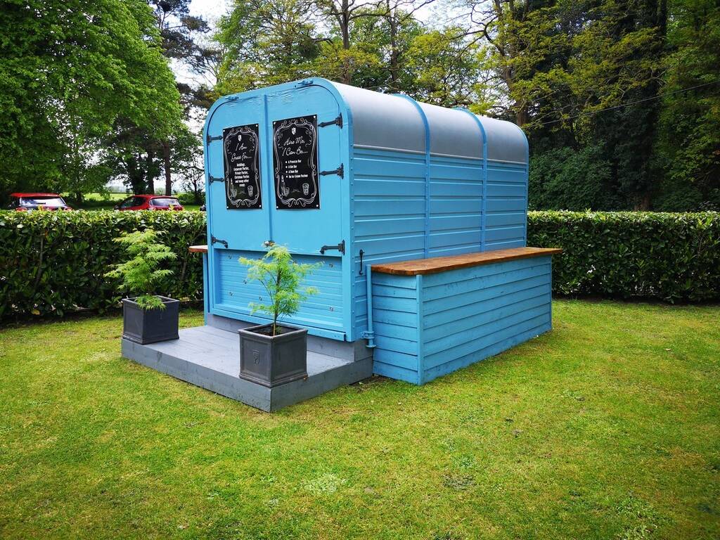 A blue horse box outside