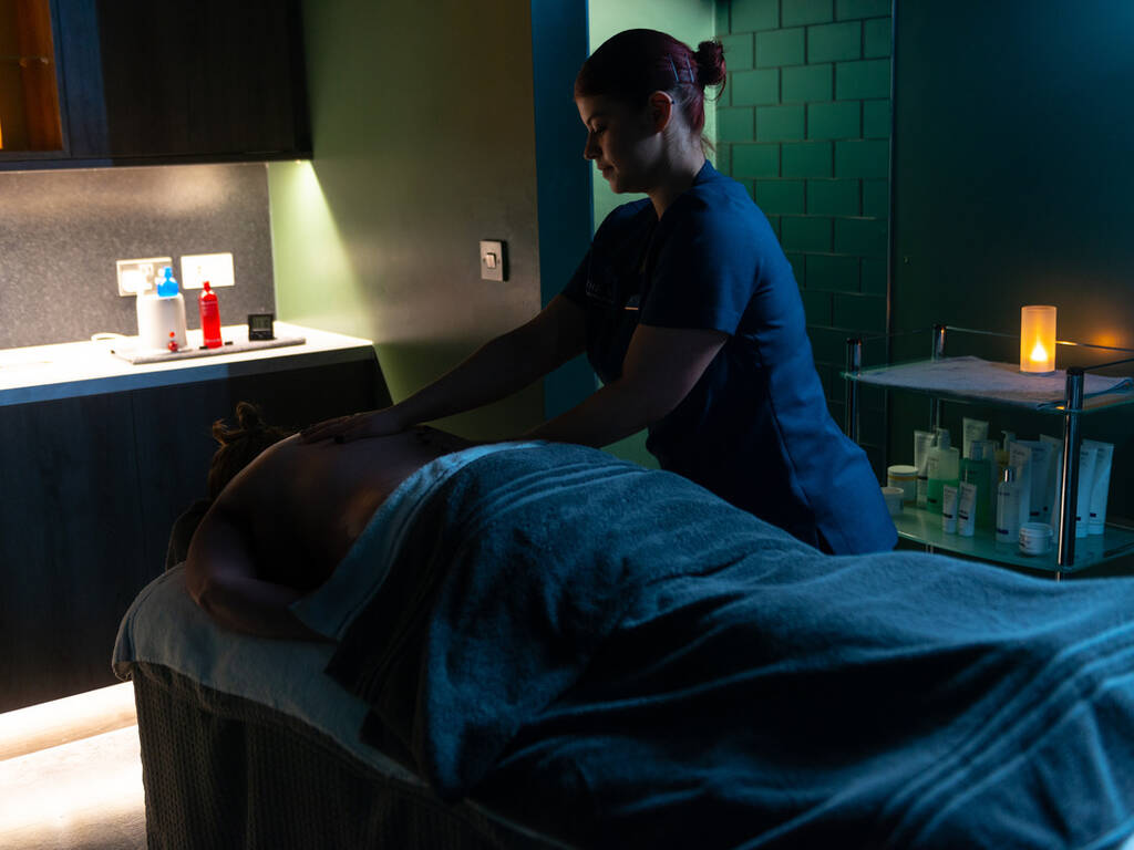 A picture of a women getting a back massage in one of the spa's treatment rooms