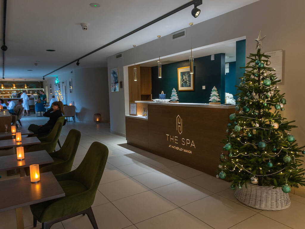 A picture of a spa reception at Christmas with a decorated Christmas tree