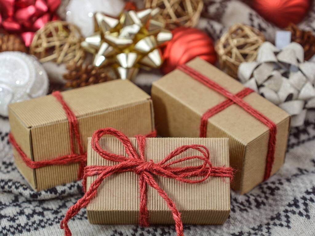 A stock image of Christmas presents with brown wrapping paper and red string