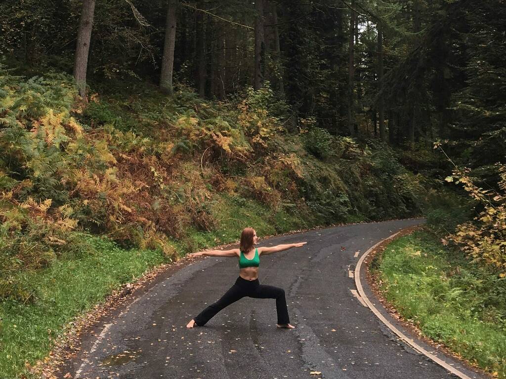 Abbey doing a yoga pose in between trees