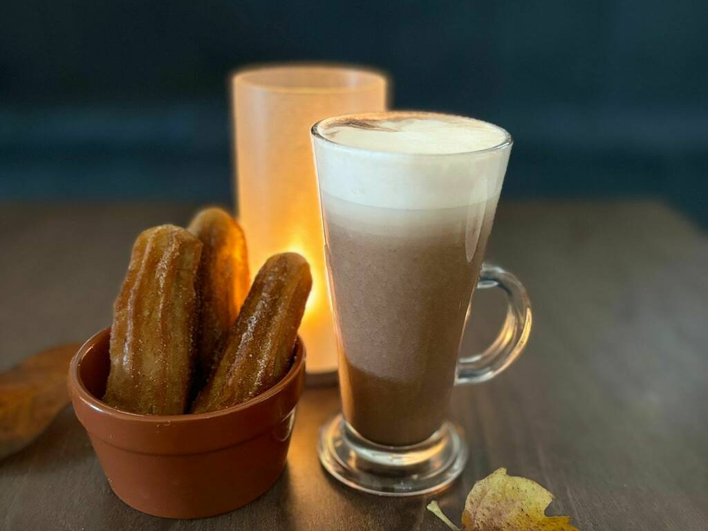 Churros and a hot chocolate on a table, spa in Gloucestershire