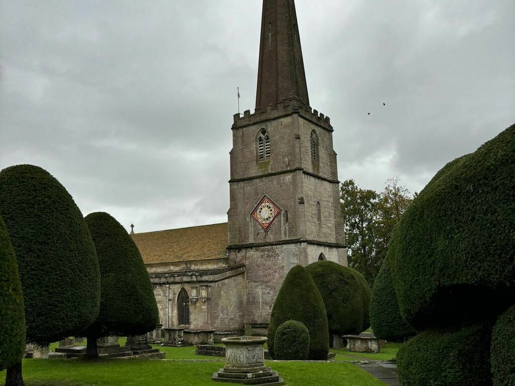 Painswick church with a view of the 99 yew trees