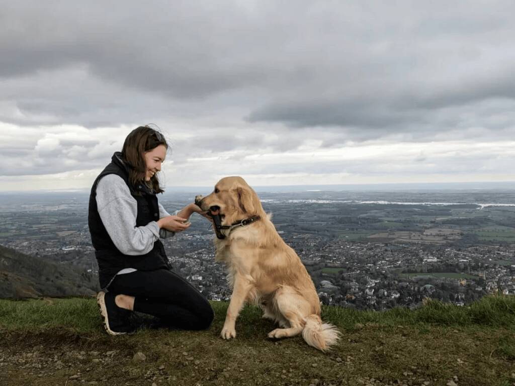 A woman and a dog at the top of the Malvern hills