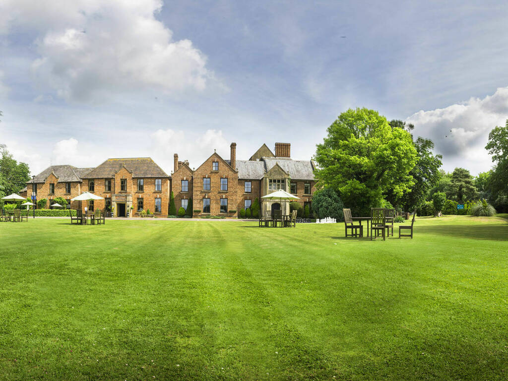 Landscape image of Hatherley Manor Hotel exterior including front lawns