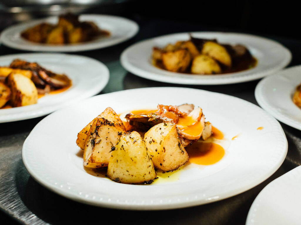 A picture of plates of food with potatoes and meat