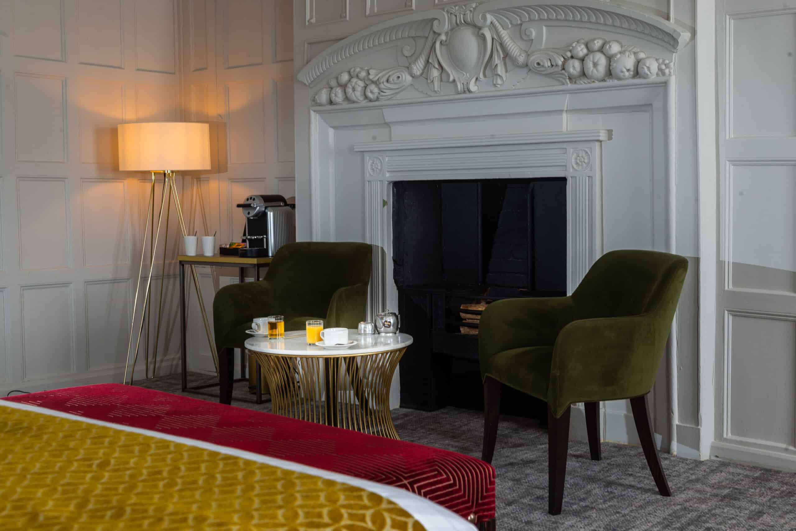 bed and fireplace at one of our rooms in Hatherley Manor, hotel gloucester