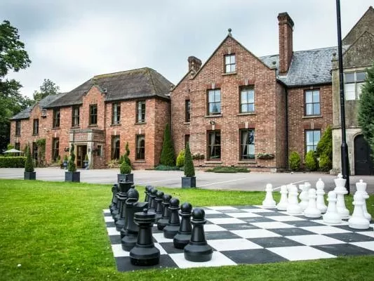 Picture of the hatherley manor hotel exterior with a chess set