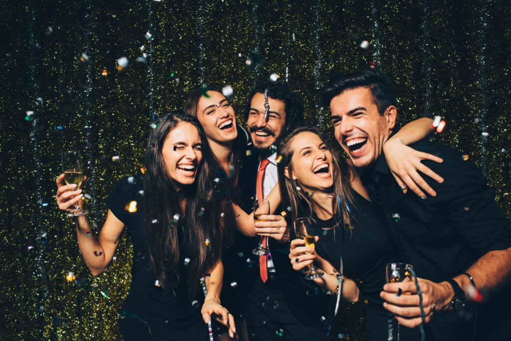 iStock 497317250 Five people at a party drinking prosecco and laughing